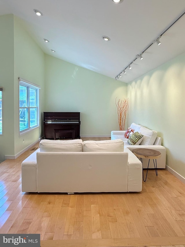 231 E Juniper Ave, Sterling, VA 20164 - living room with track lighting, light wood-style flooring, vaulted ceiling, and recessed lighting