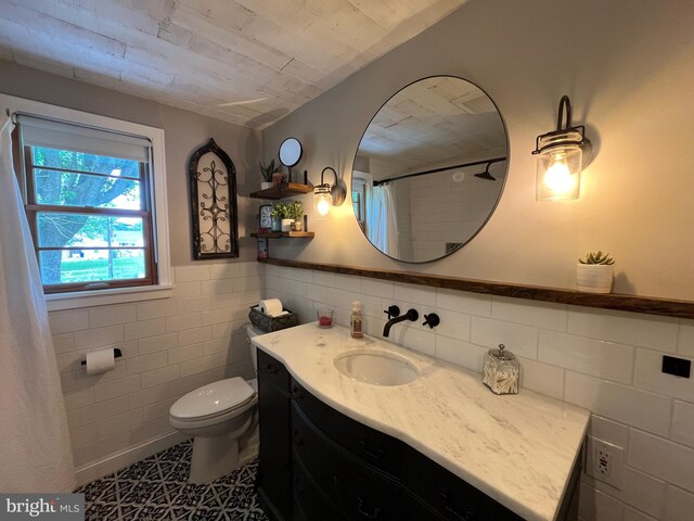 9108 Deborah Ave, Baltimore, MD 21236 - full bathroom featuring vanity, tile walls, toilet, curtained shower, and wainscoting
