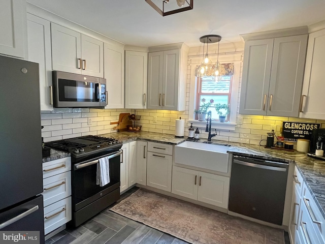 9108 Deborah Ave, Baltimore, MD 21236 - kitchen featuring appliances with stainless steel finishes, tasteful backsplash, dark stone counters, and a sink