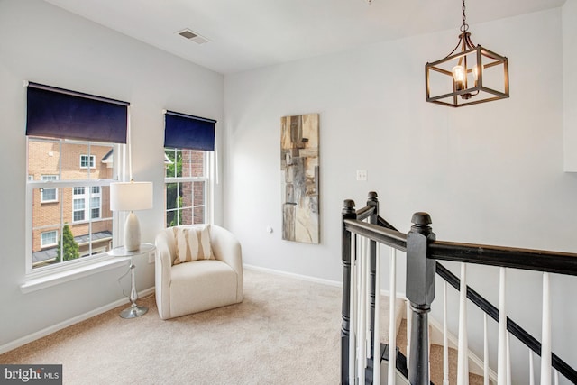 9511 Walker Way, Manassas Park, VA 20111 - living area with a chandelier, an upstairs landing, carpet, and baseboards