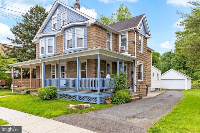 73 Fairfield Ave, Lawrence, NJ 08648 - view of front of property with covered porch, an outdoor structure, a garage, stone siding, and a front yard