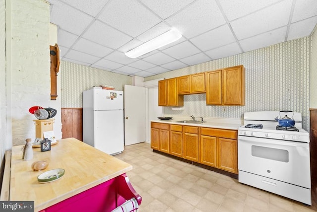73 Fairfield Ave, Lawrence, NJ 08648 - kitchen with white appliances, wallpapered walls, light floors, a paneled ceiling, and light countertops