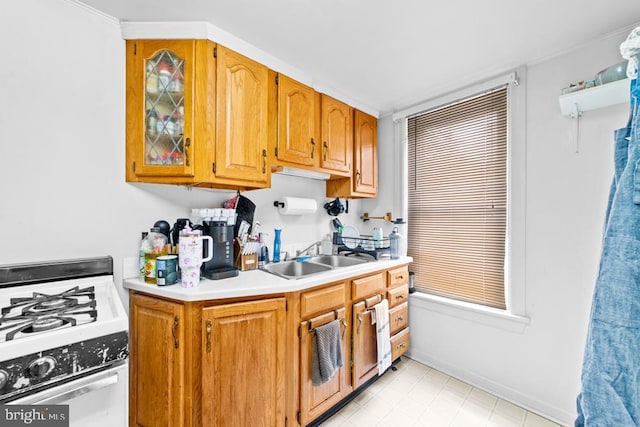 73 Fairfield Ave, Lawrence, NJ 08648 - kitchen featuring white gas range oven, light countertops, and brown cabinets