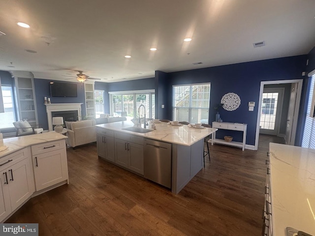 133 Henry Stoupe Way, Chester, MD 21619 - kitchen with stainless steel dishwasher, ceiling fan, a glass covered fireplace, dark wood-style flooring, and recessed lighting