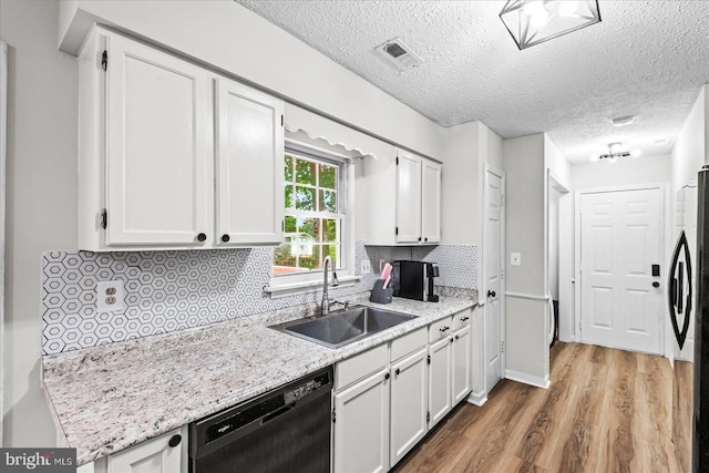 2569 N Independence Dr, Montross, VA 22520 - kitchen featuring dishwasher, wood finished floors, freestanding refrigerator, decorative backsplash, and white cabinets