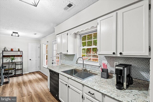 2569 N Independence Dr, Montross, VA 22520 - kitchen with black dishwasher, decorative backsplash, a textured ceiling, light wood-type flooring, and white cabinets