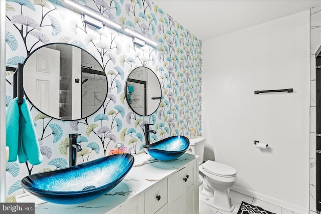 2569 N Independence Dr, Montross, VA 22520 - bathroom with wallpapered walls, vanity, and marble look tiles