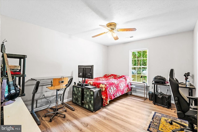 2569 N Independence Dr, Montross, VA 22520 - bedroom featuring wood finished floors, a textured ceiling, and a ceiling fan