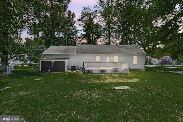 2569 N Independence Dr, Montross, VA 22520 - back of property featuring a wooden deck, a lawn, and an attached garage