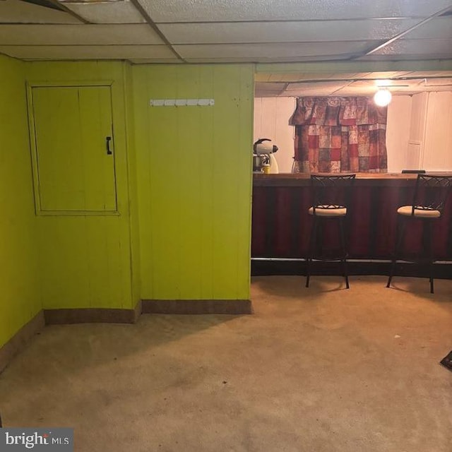 5750 N Woodstock St, Philadelphia, PA 19138 - finished below grade area with a dry bar, carpet floors, baseboards, and a paneled ceiling