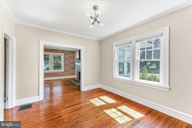 200 Winston Ave, Wilmington, DE 19804 - empty room featuring plenty of natural light, hardwood / wood-style flooring, a chandelier, crown molding, and a fireplace