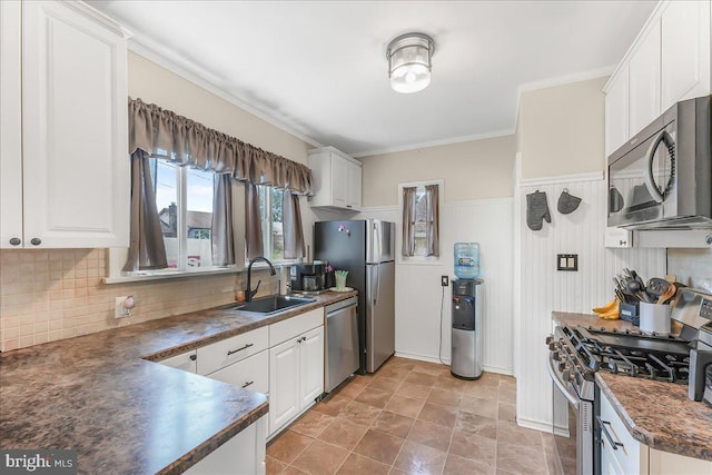 200 Winston Ave, Wilmington, DE 19804 - kitchen featuring appliances with stainless steel finishes, dark countertops, white cabinetry, decorative backsplash, and ornamental molding