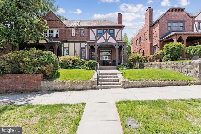 614 Oneida Pl NW, Washington, DC 20011 - view of front of house with a front yard, brick siding, and a chimney