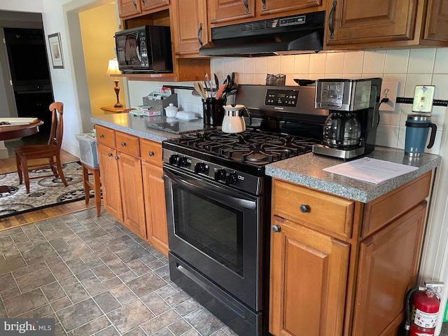 6936 Cedar Ave, Pennsauken, NJ 08109 - kitchen featuring black appliances, under cabinet range hood, decorative backsplash, and brown cabinetry