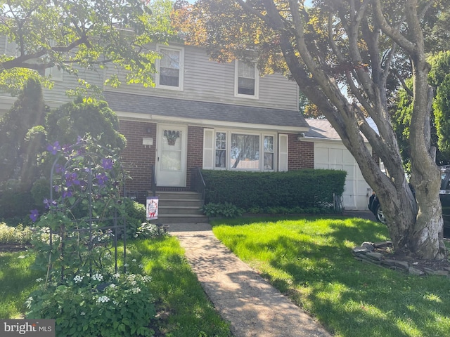 6936 Cedar Ave, Pennsauken, NJ 08109 - view of front facade with brick siding, a front yard, roof with shingles, and a garage