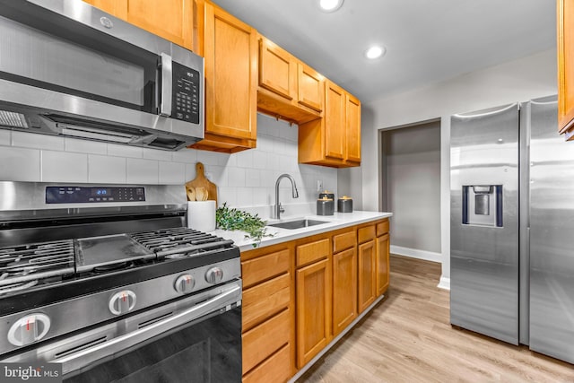 8450 Kavanagh Rd, Dundalk, MD 21222 - kitchen with stainless steel appliances, backsplash, light countertops, light wood finished floors, and recessed lighting