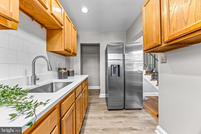 8450 Kavanagh Rd, Dundalk, MD 21222 - kitchen with stainless steel refrigerator with ice dispenser, light wood-style flooring, light countertops, decorative backsplash, and recessed lighting