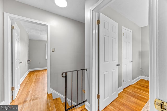 8450 Kavanagh Rd, Dundalk, MD 21222 - hallway with light wood finished floors and an upstairs landing