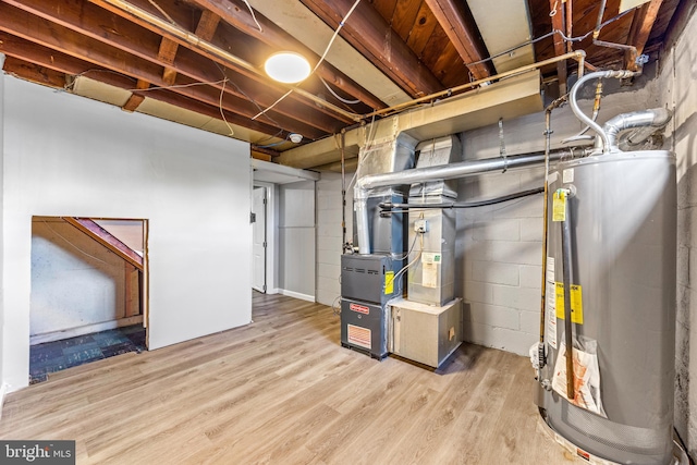 8450 Kavanagh Rd, Dundalk, MD 21222 - unfinished below grade area with water heater, wood finished floors, and heating unit