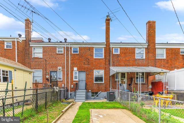 8450 Kavanagh Rd, Dundalk, MD 21222 - rear view of property with brick siding, a fenced front yard, and entry steps