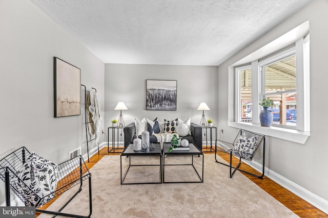 8450 Kavanagh Rd, Dundalk, MD 21222 - living area featuring a textured ceiling and wood finished floors