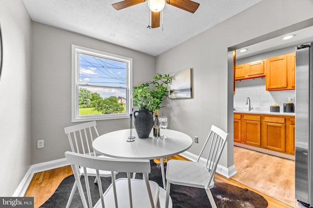 8450 Kavanagh Rd, Dundalk, MD 21222 - dining room with light wood-style floors, a textured ceiling, a ceiling fan, and recessed lighting