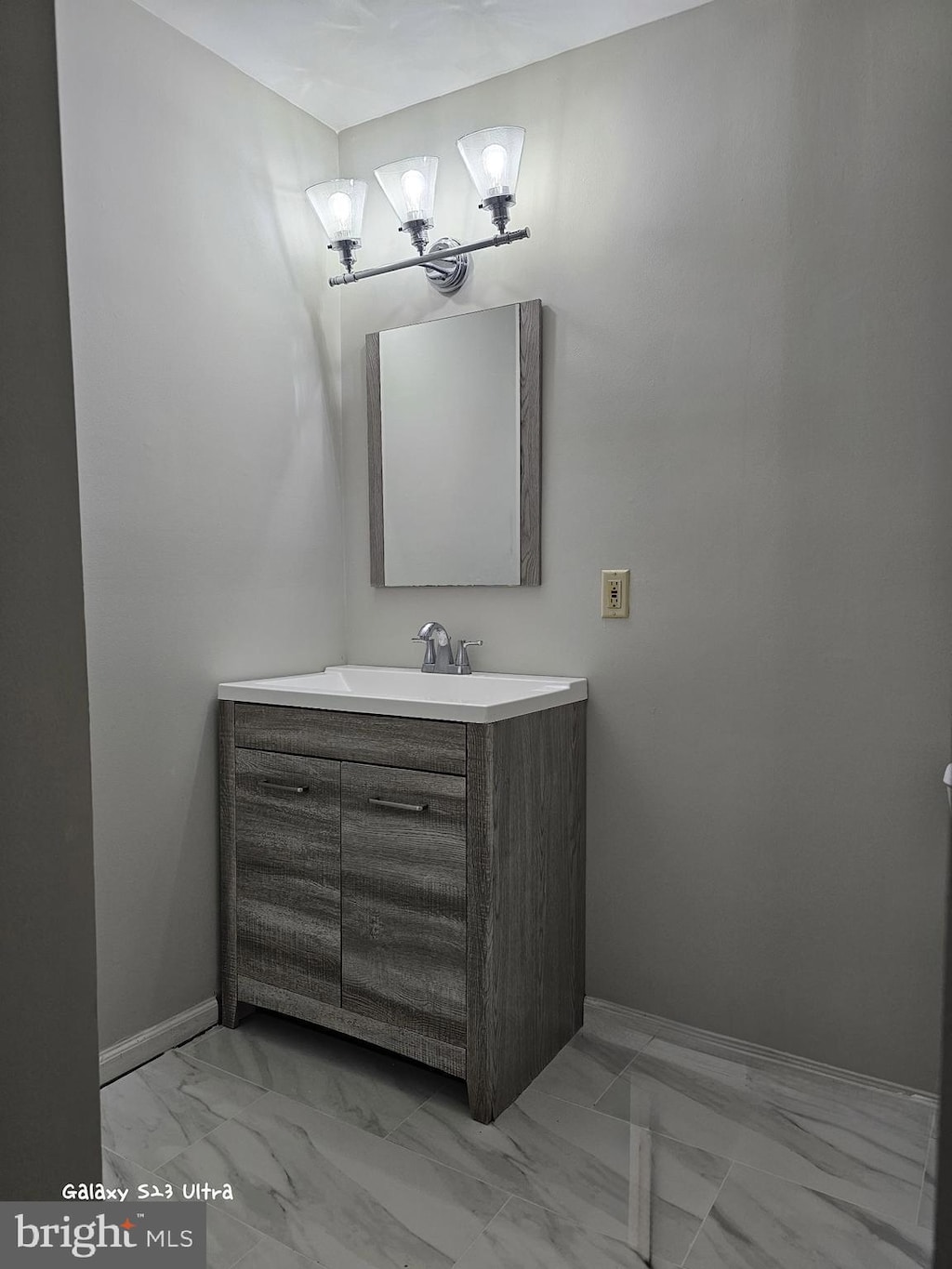 14804 Hancock Ct, Centreville, VA 20120 - bathroom with marble look tiles, vanity, and a chandelier