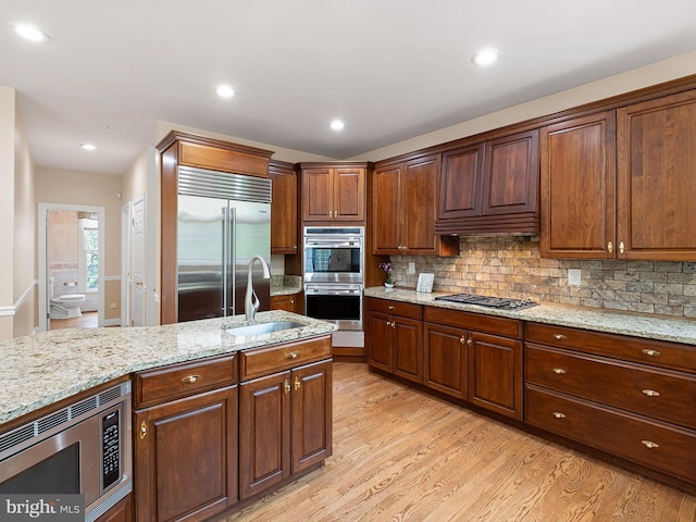 2 N Pheasants Rdg N, Wilmington, DE 19807 - kitchen with built in appliances, a sink, light wood-type flooring, decorative backsplash, and recessed lighting
