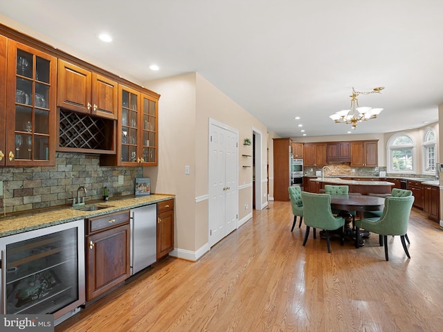 2 N Pheasants Rdg N, Wilmington, DE 19807 - kitchen featuring wine cooler, refrigerator, a sink, decorative backsplash, and a chandelier