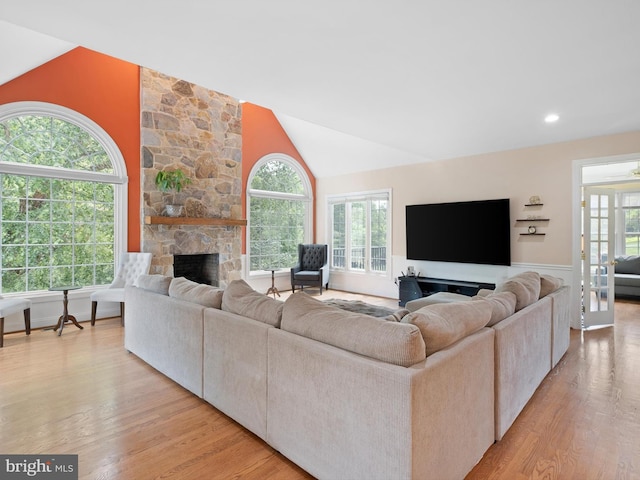 2 N Pheasants Rdg N, Wilmington, DE 19807 - living area with light wood-type flooring, a stone fireplace, and vaulted ceiling