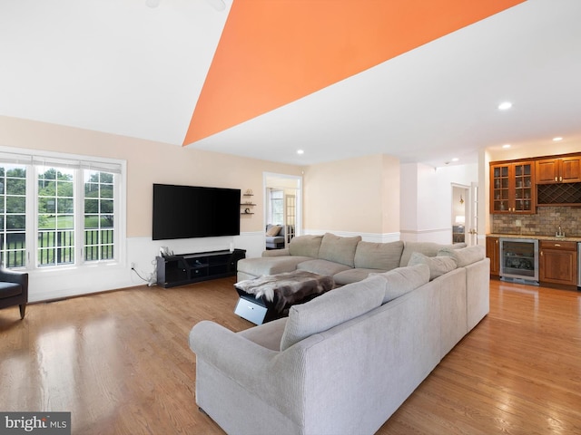 2 N Pheasants Rdg N, Wilmington, DE 19807 - living room featuring wine cooler, bar area, plenty of natural light, light wood finished floors, and a high ceiling