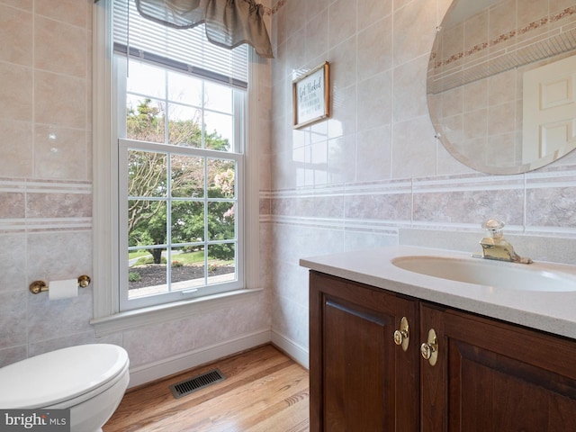 2 N Pheasants Rdg N, Wilmington, DE 19807 - bathroom with vanity, plenty of natural light, wood finished floors, baseboards, and tile walls