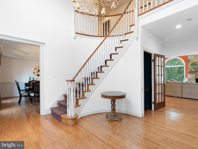 2 N Pheasants Rdg N, Wilmington, DE 19807 - stairs with a chandelier, wood finished floors, and a towering ceiling