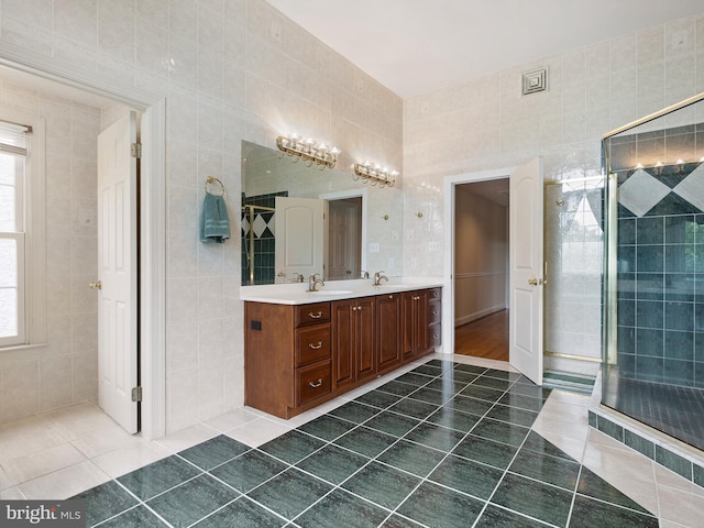 2 N Pheasants Rdg N, Wilmington, DE 19807 - full bath with tile patterned flooring, double vanity, healthy amount of natural light, tile walls, and tiled shower
