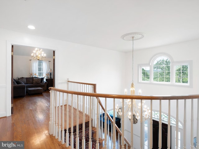 2 N Pheasants Rdg N, Wilmington, DE 19807 - hallway featuring a chandelier, an upstairs landing, and wood finished floors