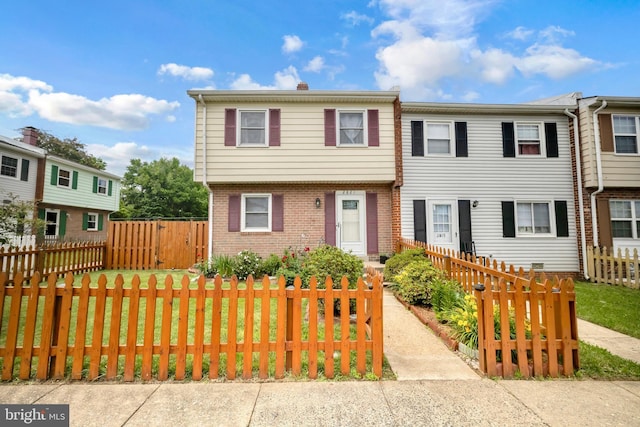 2821 Banks Ct, Dumfries, VA 22026 - multi unit property with brick siding, a fenced front yard, and a chimney