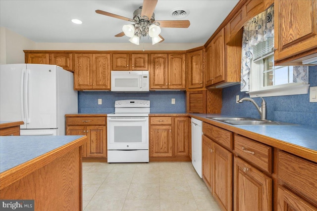 13336 Marquise Dr, Hagerstown, MD 21742 - kitchen with white appliances, a sink, brown cabinetry, light tile patterned floors, and a ceiling fan