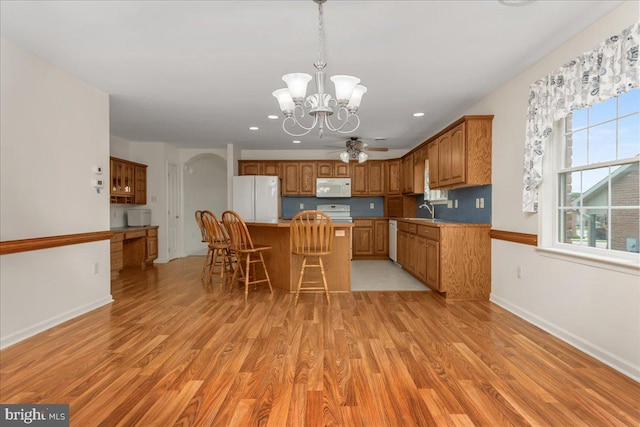 13336 Marquise Dr, Hagerstown, MD 21742 - kitchen featuring white appliances, a chandelier, light wood-style flooring, a sink, and recessed lighting