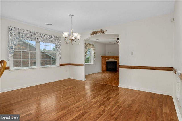 13336 Marquise Dr, Hagerstown, MD 21742 - unfurnished room featuring a chandelier, light wood-style flooring, ceiling fan, a fireplace, and baseboards