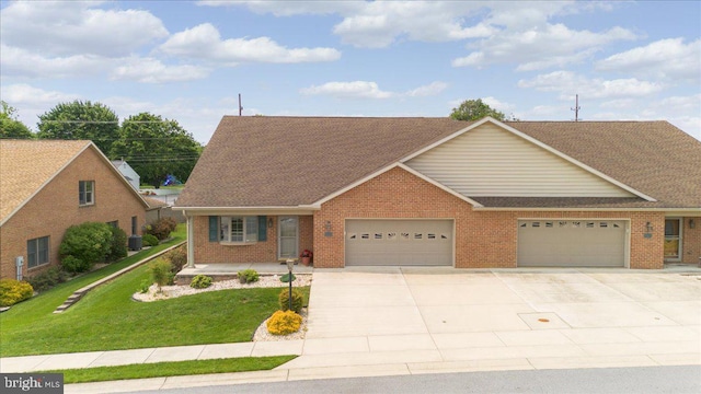 13336 Marquise Dr, Hagerstown, MD 21742 - view of front facade featuring a garage, concrete driveway, a front yard, a shingled roof, and brick siding
