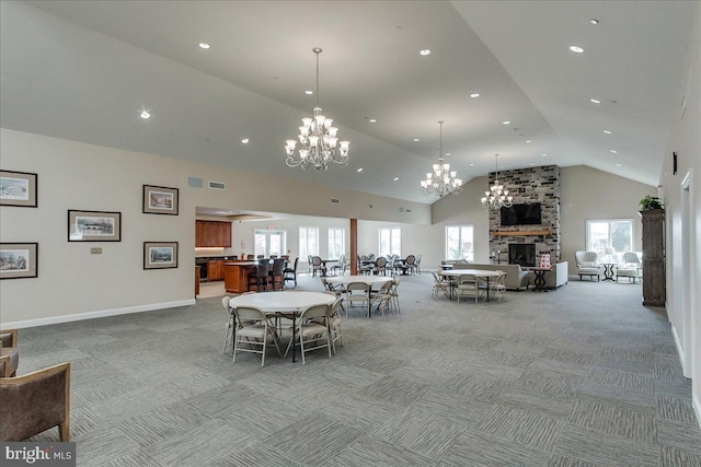 13336 Marquise Dr, Hagerstown, MD 21742 - dining space featuring light colored carpet, a chandelier, a stone fireplace, recessed lighting, and high vaulted ceiling