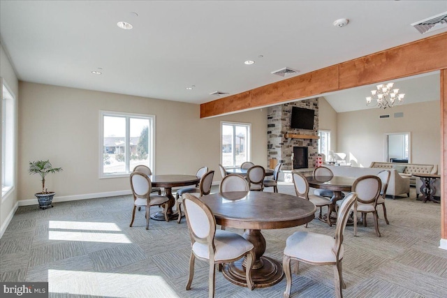 13336 Marquise Dr, Hagerstown, MD 21742 - dining space with light colored carpet, a chandelier, a stone fireplace, baseboards, and recessed lighting