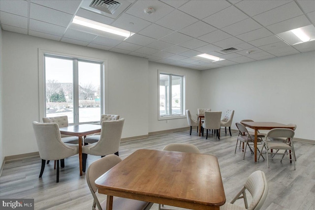 13336 Marquise Dr, Hagerstown, MD 21742 - dining space featuring healthy amount of natural light, light wood-type flooring, a drop ceiling, and baseboards