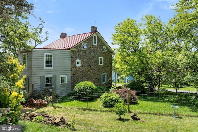 2355 Little Rd, Perkiomenville, PA 18074 - view of side of property featuring a chimney, stone siding, a standing seam roof, and a metal roof
