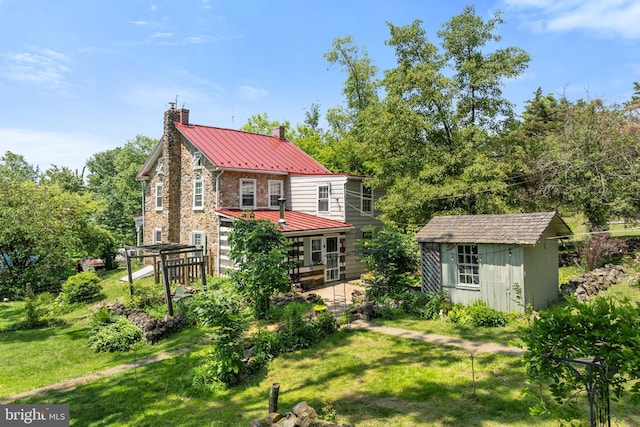 2355 Little Rd, Perkiomenville, PA 18074 - rear view of house with a chimney, a storage shed, a deck, and a yard