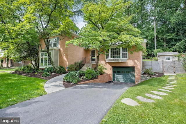 10412 Kinloch Rd, Silver Spring, MD 20903 - view of front of house with driveway, an attached garage, and brick siding