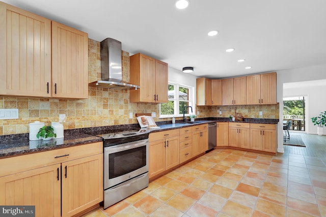2725 Woodridge Ct, West Friendship, MD 21794 - kitchen with wall chimney range hood, appliances with stainless steel finishes, light brown cabinetry, plenty of natural light, and recessed lighting