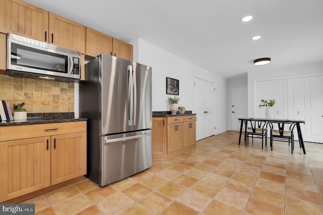 2725 Woodridge Ct, West Friendship, MD 21794 - kitchen with stainless steel appliances, decorative backsplash, recessed lighting, dark stone countertops, and light brown cabinets