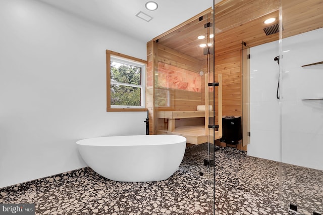 2725 Woodridge Ct, West Friendship, MD 21794 - bathroom featuring recessed lighting, a soaking tub, a stall shower, and wood walls