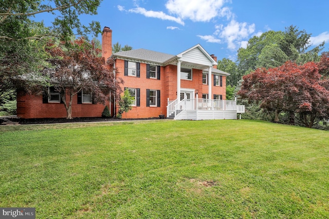 2725 Woodridge Ct, West Friendship, MD 21794 - view of front facade with a chimney, a front lawn, brick siding, and a deck